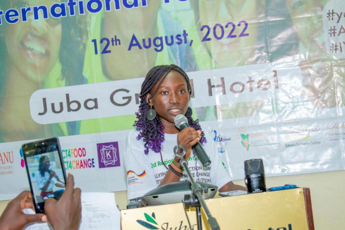 A young speaker addresses a crowd of youth volunteers. The event was hosted by Action Against Hunger in 2022 in Juba, South Sudan.